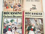 three books of french children ' s literature on display on a table