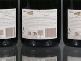 three bottles of wine sitting on top of a table next to each other