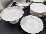 a lot of plates and bowls sitting on a table