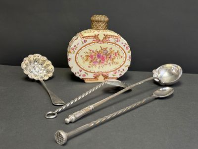 trois cuillères en argent et deux cuillères en argent posées sur une table