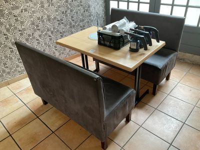 a table with two chairs and a coffee maker on it