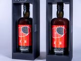 two bottles of wine in a black box on a white background
