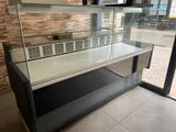 a glass display case in the middle of a room