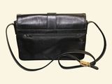 black leather cross body bag with gold hardware on strap