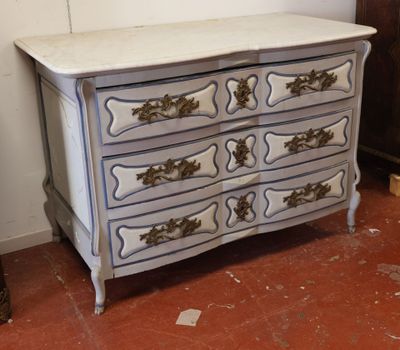 a white dresser with a blue and gold design on it