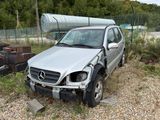 a silver car that is sitting in the dirt