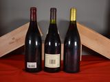 three bottles of wine sitting next to each other on a table