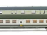 three green and white train cars on a white surface