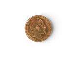a close up of a penny on a white surface with a white background
