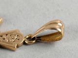 a gold cross with a heart on it sitting on a table