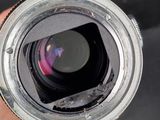 a person holding a camera lens in their hand