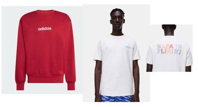 a man in a white shirt and blue shorts standing next to a red sweatshirt