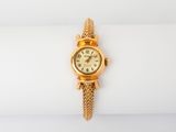 an image of a woman ' s wrist watch on a white surface