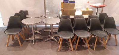 many chairs and tables in a room with a table and umbrella