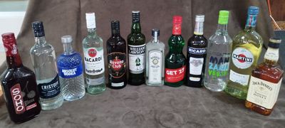 de nombreuses bouteilles d'alcool de toutes sortes alignées sur une chaise