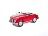 a red toy car that is sitting on a white surface