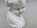 a close up of a white bust of a child on a blue base