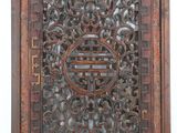 an old wooden carved panel with a circular design on it