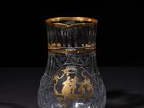 a close up of a glass vase on a table with a black background