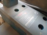 a close up of a piece of metal with holes in it