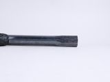 a black pipe that is sitting on a white surface