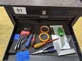 many tools in a tool box on the floor