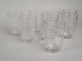 six glasses sitting next to each other on a table