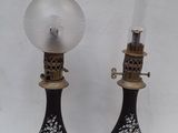 pair of black and gold vases with a clear glass on top
