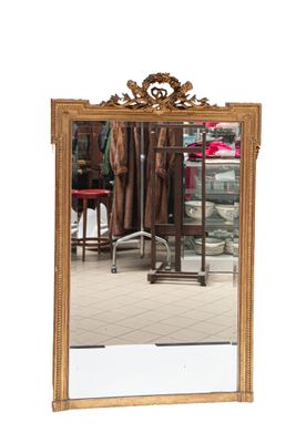 a mirror that is sitting on the floor in front of a chair
