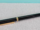 a close up of a pen sitting on top of a table