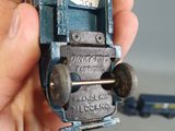 a person holding a toy car in their hand