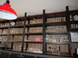 a red light hanging over a shelf filled with wine glasses