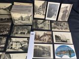 several old black and white photographs of buildings and buildings on a table