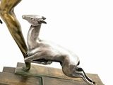 bronze statue of a woman and a deer on a marble base