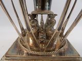 a silver vase with birds on it on a stand