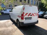 a white van that is parked on the side of the street