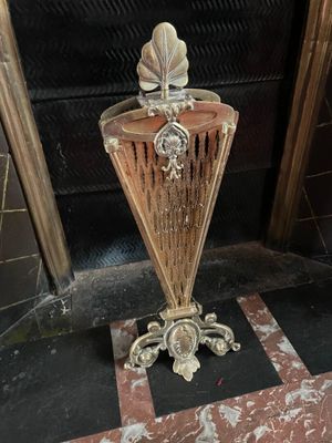 a vase that is sitting on the floor in front of a door