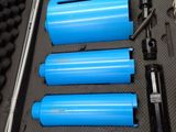 six blue bullet shells in a metal case on a table