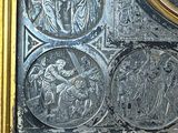 a picture of a gold and silver clock with religious images on it