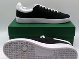 black and white tennis shoes on top of a green box