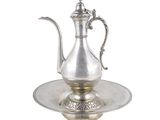 un plateau ancien en argent sur lequel est posée une théière en argent