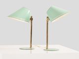 a pair of green lamps on a white table