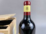 a bottle of wine sitting next to a wooden box