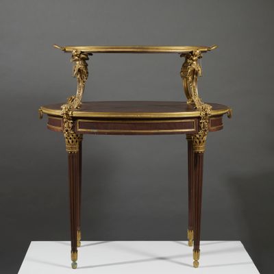 an antique console table with a marble top on a white pedestal