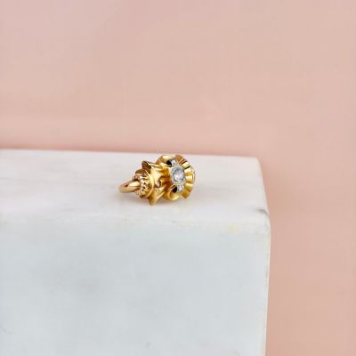a close up of a gold ring on a marble block