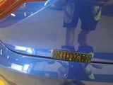 a sticker on the back of a blue car