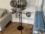 a lamp that is on a stand next to a radiator