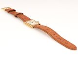 a close up of a watch on a white surface