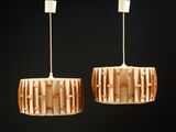 deux lampes en bois suspendues au plafond dans une pièce sombre