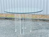 an image of a clear glass table with a metal base